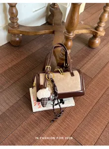 Vintage color-block Boston handbag with chic charm, perfect for daily commuting and stylish outfits.