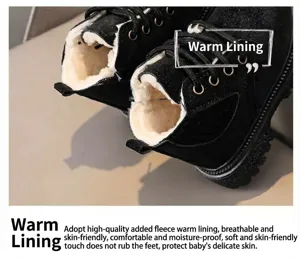 Kids black martin boots detail showing soft plush warm inner lining and anti-slip sole.