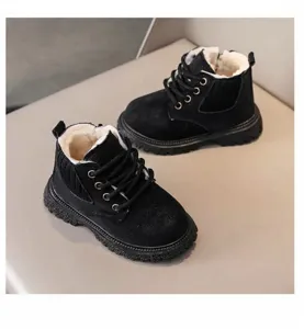 Close-up detail of black children winter boots with plush lining, side zipper and laces.