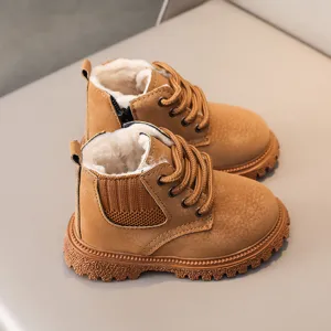 Close-up detail of kids brown winter boots with warm plush lining and anti-slip thick sole.