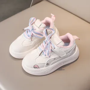 Kids casual sneakers detail view, soft sole retro shoes in cute white and pink color.