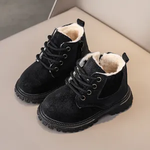 Detail view of black kids winter boots with cozy plush lining, thick sole and zipper.