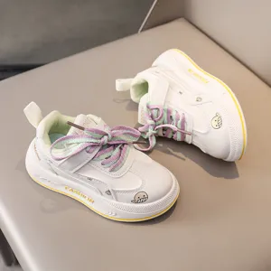 Kids casual sports sneakers detail view, featuring white upper and colorful laces with whale print.