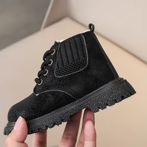 Close-up detail shot of black kids winter boots, soft velvet lining and anti-slip thick sole.