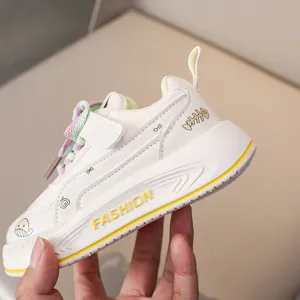 Kids casual sports sneakers, white design with colorful laces and cute side pattern details.