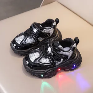 Kids light up sneakers detail shot, black and silver glitter mesh, chunky soft sole.