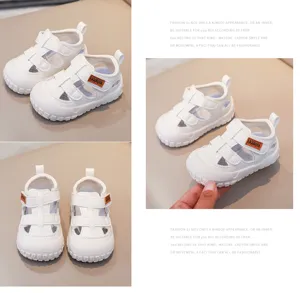 White baby toddler sandals with hook and loop closure and hollow breathable mesh design for summer.