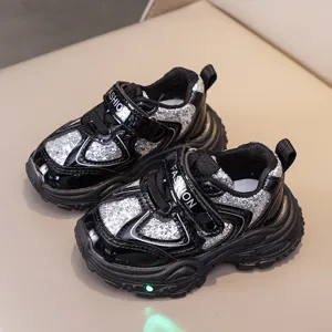 Kids light-up mesh running shoes detail view, showing breathable glitter upper and chunky sole.