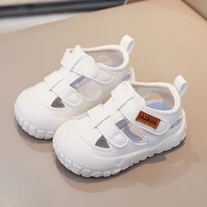White baby toddler sandals with velcro closure, breathable hollow design, soft and non-slip sole.