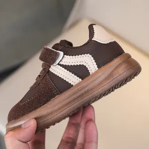 Kids brown casual sneakers with velcro strap and stylish side wavy stripes for boys and girls.