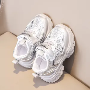 Silver glitter children sports shoes detail shot, breathable mesh upper with velcro strap.