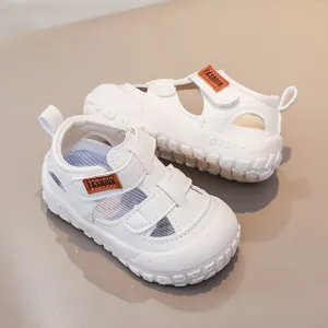 Toddler white summer sandals, breathable hollow design with velcro straps and soft non-slip soles.