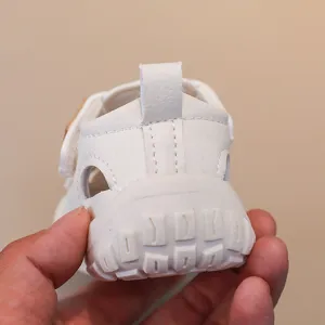 White baby toddler summer sandals featuring soft anti-slip sole velcro and hollow design detail
