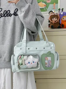 Green canvas ita tote bag with clear window, star plush, and apple pocket for daily use.