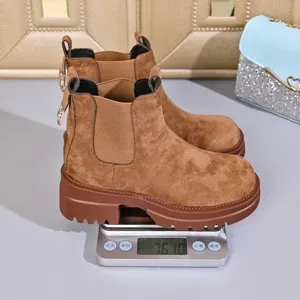 Brown suede Chelsea boots for women, thick platform round toe ankle booties with scale.