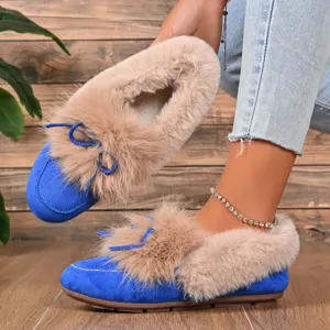 Winter plush warm flat shoes detail, cozy blue suede loafers with fluffy beige faux fur trim.