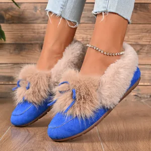 Detail shot of warm winter furry flat shoes in blue with cozy beige plush lining.