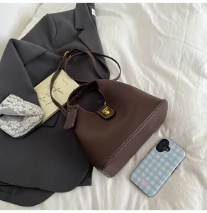 Retro dark brown leather bucket bag for women, stylish casual shoulder and crossbody bag.