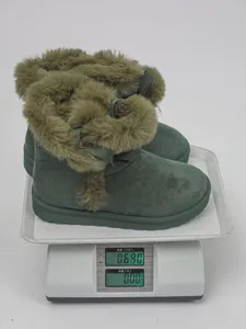 Women's short snow boots with plush lining, thick sole, and cute bow decoration for winter warmth.