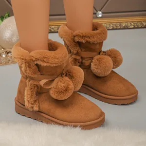 Women's short snow boots with plush lining, cute bow and pom-pom decorations for winter warmth.