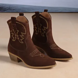 Brown suede western cowboy boots detail shot showing delicate golden embroidery and chunky heel.