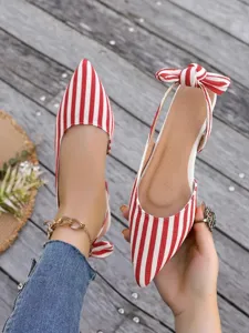 Red and white striped slingback flat shoes featuring a pointed toe and cute bow detail.