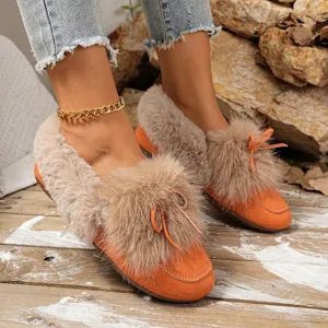 Orange fluffy plush warm flat shoes for women, cozy winter footwear with bow detail.