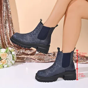 Detailed view of women platform chelsea boots with leopard print and star embroidery design.