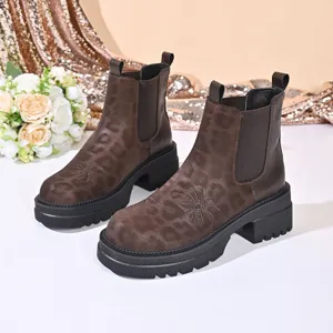 Detail view of vintage leopard print chunky Chelsea boots showing embroidery and textured rubber sole.