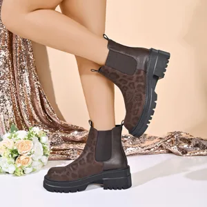 Close-up detail of retro leopard print Chelsea boots featuring thick soles and floral embroidery.