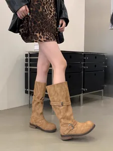 Retro buckle slouch boots detail view showing chunky heel and stylish pleats for autumn.