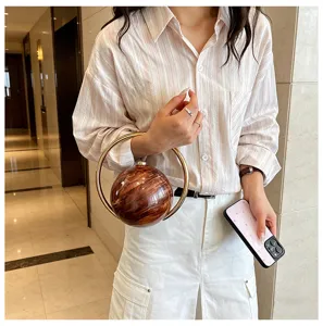 Sphere metal ring handle evening handbag stylish marble texture designer clutch detail view