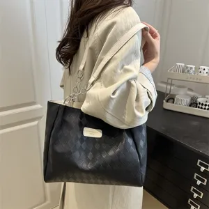 Detailed view of women large capacity black tote bag with diamond pattern and metal chain strap.