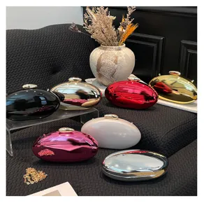 Elegant metallic oval clutch bag set with glossy mirror finish and detachable chain strap.