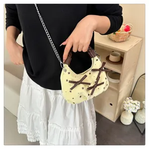 Detail view of a chic niche handbag featuring light yellow star print and cute brown bow design.