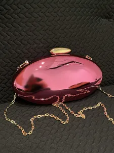 Pink mirror acrylic oval evening clutch bag with gold chain strap for women main view.