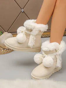 Charming women's winter snow boots with cute bow and fluffy pom-pom accents, cozy plush lining.