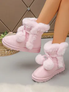 Pink fuzzy snow boots for women, short shaft with cute bow and pom-pom decor, thick sole.