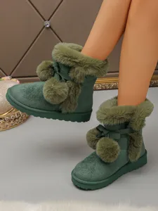 Green furry winter snow boots for women, featuring cute pom-poms and bow decor, thick platform.