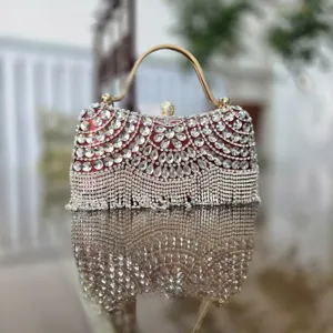 Detailed close-up of elegant rhinestone evening clutch with sparkling crystals and tassel fringe.