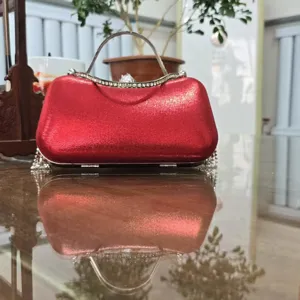 Red evening clutch bag with sparkling rhinestones, metal handle and stylish tassel details for parties.
