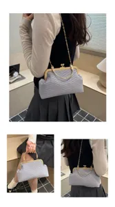 Detailed view of grey crinkled evening bag, showcasing gold clasp and chain strap.