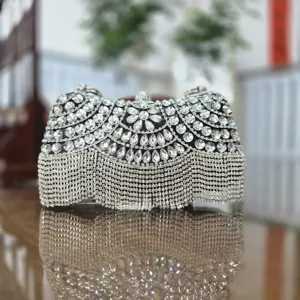 Close-up detail view of the sparkling rhinestone evening clutch bag with elegant crystal fringe.