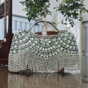 Green crystal evening clutch bag with metallic top handle and sparkling rhinestone fringe.