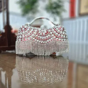 Elegant rhinestone evening clutch bag with sparkling crystal fringe and metal handle for women.