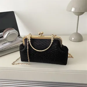 Black pleated evening bag with gold kiss-lock frame and chain strap for women chic style