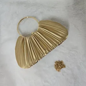 Gold pleated evening clutch bag with round metal handle and chain strap for party banquets.