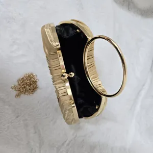 Gold pleated evening clutch bag with metal round ring handle and chain strap for party.