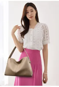 Detailed view of a stylish beige shoulder bag with minimalist design, perfect for daily use.