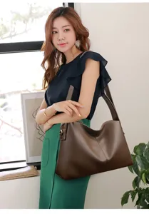 Detail shot of a stylish dark brown leather shoulder bag worn by model, spacious tote.